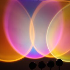 three circles are shown in front of a wall with four lights on it and one is blurry