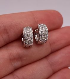 These are beautiful diamond huggie earrings set with beautiful Natural Diamonds in Solid 14Kt Gold.  The diamonds sparkles and shines beautifully. Diamond info: Diamonds: 38 Diamond cut: Round Diamond weight: 0.76 carats Color: G-H Clarity: SI2 Metal info: Metal: 14Kt Gold Metal Weight: 6.5 Grams Earring Size: 11.40mm (0.448 inches) x 12.35mm (0.486 inches) x 5.50mm(0.216 inches) 2mm thickness  WE HAVE MORE BEAUTIFUL DIAMOND JEWELRY THAT YOU CAN SEE IN OUR STORE AND IS ALL AVAILABLE IN WHITE, YELLOW AND ROSE GOLD. Want to see more photos and videos of my jewelry and how its made? Follow us on Instagram instagram.com/elizabethjewelryinc @elizabethjewelryinc Follow us on Facebook Facebook.com/Elizabethjewelryinc Dazzling White Gold Diamond Earrings With Pave Setting, Dazzling Brilliant Cut Diamond Earrings, Fine Jewelry Sparkling Diamond Earrings, Dazzling Diamond White Hoop Earrings With Pave Setting, Dazzling White Gold Huggie Earrings With Cubic Zirconia, Luxury Diamond White Brilliant Cut Huggie Earrings, Luxury Diamond Huggie Earrings In Diamond White, Luxury Diamond White Diamond Huggie Earrings, Sparkling Diamond Round Huggie Earrings