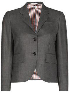 Grey wool single-breasted wool blazer from THOM BROWNE featuring signature grosgrain loop tab, RWB stripe lining, notched lapels, front button fastening, long sleeves, chest welt pocket, two side flap pockets, buttoned cuffs and English rear vents. | Thom Browne Single-Breasted Wool Blazer Thom Browne Suit, Versace Outfit, Summer Beach Wear, Ski Wear, Wool Blazer, Thom Browne, Sport Coat, World Of Fashion, Single Breasted