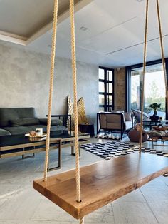 a living room filled with furniture and a wooden swing