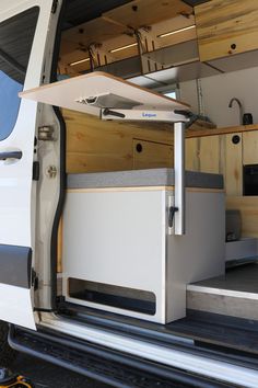 the interior of a van with its door open and cabinets in place on the side