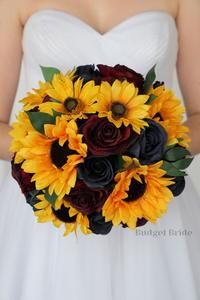 a bride holding a bouquet of sunflowers and roses