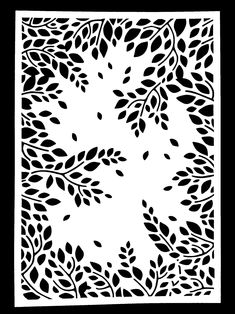 a black and white paper cutout with leaves