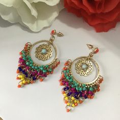 Very beautiful, elegant and high quality hand crafted golden multi colour earrings will add charm and charisma to your beautiful personality. Wear it with any of your formal or casual outfits and grab compliments all the way. Main Colour: gold Beads: Seed Bead Bead Colour: Multi Colour  Earrings Size: L x 7.7 cm / W x 3.8 cm Luxury Multicolor Bollywood Jhumkas, Bohemian Multicolor Flower Earrings For Party, Nickel Free Multicolor Metal Hoop Earrings, Nickel-free Multicolor Metal Hoop Earrings, Multicolor Metal Hoop Earrings For Pierced Ears, Yellow Bohemian Earrings With Latkans, Traditional Gold Tassel Earrings For Festivals, Multicolor Metal Hoop Earrings, Bohemian Yellow Earrings With Latkans