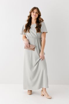 The modest formal maxi dress that you have been waiting for! The ‘Naomi’ is effortless and feminine - the perfect pick for family photos, an elegant party, or a modest bridesmaid dress. This timeless dress features a modest scoop neckline, flutter sleeves, and a chiffon overlay. The lightly gathered elastic waist and zipper closure allow for ease of styling and a flattering fit. This dress is fully lined - no layering required! Exclusively designed with you in mind. Self & Lining 100% Polyester Modest Maternity Dresses, Modest Bridesmaid Dress, Formal Maxi Dress, Maternity Bridesmaid Dresses, Solid Maxi Dress, Short Maxi Dress, Modest Bridesmaid Dresses, Timeless Dress, Chiffon Overlay