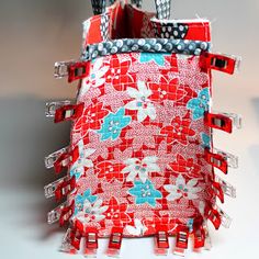 a red and white bag with flowers on it