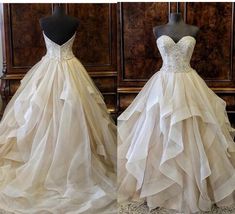 two wedding gowns on mannequins in front of a wooden wall and floor