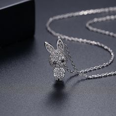 Silver-plated pendant necklace with sparkling cubic zirconia. Chain : 15.75" L with 1.96" extender Pendant : 0.33" W x 0.8" L Lobster claw clasp Silver-plated copper / cubic zirconia Silver Bunny Design Jewelry For Gifts, Nickel-free Cubic Zirconia Pendant Jewelry, Silver Bunny Design Jewelry Gift, Rabbit Necklace Pendants, Rabbit Pendant, Cubic Zirconia, Silver Plate, Copper, Sparkle