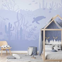 a child's bedroom decorated in blue and white with an underwater scene painted on the wall