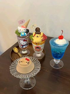 there are three desserts on the table with ice cream and water in glasses next to each other