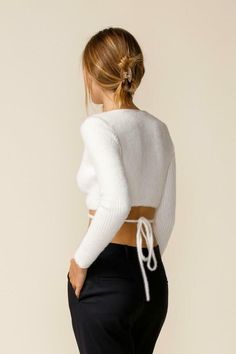 Final Sale - Get it before it's gone! Get a cute fall look with the Mimi White Wrap Cropped Sweater Top and high-waisted jeans! White ribbed Medium-weight stretch knit shapes this sweater top that has long sleeves and a surplice neckline that flows into a wrapping bodice. Two long straps tie together at the back below the cropped hem. Style with your favorite 90's jeans for a cute fall look! DETAILS & CARE Viscose. Hand wash cold. Imported. ORDERS, SHIPPING & RETURNS Orders, Shipping, & Returns Chic Ribbed Cropped Sweater For Fall, Trendy Cropped Sweater For Fall Layering, Cozy Stretch Ribbed Cropped Sweater, Stretch Ribbed Cropped Sweater For Fall, Cozy Fitted Knit Top For Fall, Trendy Stretch Knit Top For Winter, Chic Stretch Cropped Sweater In Soft Knit, Stretch Cropped Sweater With Soft Knit And Long Sleeves, Chic Knit Cropped Sweater For Fall