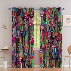 the curtains are decorated with multicolored feathers on them and hanging in front of a window