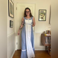 This is a gorgeous 1970s vintage prairie dress. Made by Gunne Sax, it is a sleeveless sundress in a blue gingham. The dress has a faux white apron down the front, a corset bust and tiered bottom. The skirt has a ton of volume - what gunnies are known for! There is crochet detailing under the bust and the dress ties and zips in the back. Overall in good vintage condition - there was a hole in the front that has been repaired - see pics. Tag is faded somewhat - dress is marked a size 11 with measurements in photos. Can be sized up slightly due to the corset style bust. Approx a medium. Dresses 70s, Vintage Prairie Dress, Sleeveless Sundress, White Apron, Gunne Sax, Prairie Dress, 70s Vintage, Blue Gingham, Corset Style