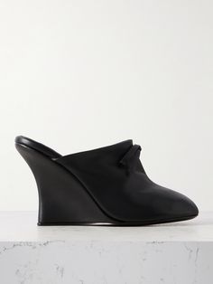 Inspired by slippers, Marie Adam-Leenaerdt's mules have been crafted in Italy from leather that's naturally soft and stretchy. They're topped with dainty bows and set on slim 100mm wedges. Elegant Slip-on Clogs With Sculpted Heel, Elegant Leather Clogs With Sculpted Heel, Evening Leather Mules With Round Toe, Leather Mules For Evening With Round Toe, Spring Leather Clogs With Wrapped Heel, Elegant Clogs With Sculpted Heel, Leather Mules With Round Toe For Evening, Elegant Wedge Heel Mules With Deep Heel Cup, Luxury Leather Clogs For Spring