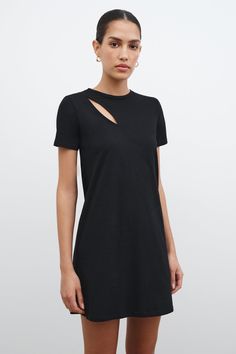 You could live in Leonie, the black t-shirt dress inspired by our best-selling Leonie Tee. Her European organic cotton jersey fabric and relaxed fit make her the perfectly comfortable day-to-night staple. But Leonie's geometrically chic front cutout and cropped length also deliver personality and edge to your everyday. This black cutout dress offers short sleeves and a crew neckline.[SPLIT] Astrid is 5'9" (175 cm) tall, wearing size XS. Total length is approximately 33" (84.5 cm). French Organic Black T-shirt Dress For Loungewear, Casual Mini Dress With Cutout And Short Sleeves, Modern Black Cotton Dresses, Black Cutout Dress, Dress With Short Sleeves, Cotton Jersey Fabric, Sweatshirt Fabric, Fun Fashion, Cutout Dress