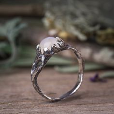 "Moonstone rainbow magical twig ring in Sterling silver. Delicate tree bark textured ring. * Size and details: The ring width on the front side - 0.3\" (8 mm) The ring width on the back side - 0.07\" (2 mm) * Material: Sterling silver 925 with oxidised finish. * Genuine moonstone gemstone in 7 mm. * Colors: white - transparent with a flash of colourful blue. * All my jewelry are handmade by me and inspired by my love to nature, ancient cultures and my practice in energy world. This ring is packe Mystical Silver Crystal Ring, Silver Mystical Moonstone Ring, Handmade Mystical Silver Rings, Mystical Sterling Silver Rings, Branch Ring Engagement, Nature-inspired Silver Moonstone Ring, Fairy Tale Ring, Witchy Engagement Ring, Earthy Rings