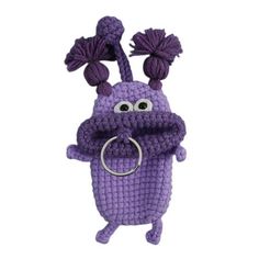 a purple crocheted toy with two pom poms on it's head