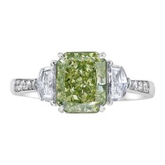 Our new line of diamonds with flavors of green in them set in a ring with green painted enamel under the diamond to make it appear as a pure green diamond. The diamond is 100% natural and GIA certified, but the ring is colored underneath the stone to enhance the green color. Certified as a Fancy Brownish Greenish Yellow Extremely lively and gorgeous green color 100% eye clean Set in 18kt Gold with 0.31ct of step cut trapezoids and 0.13ct of round diamonds Making Extraordinary Attainable with Rar Exquisite Green Diamond Ring Luxury, Colored Diamond Jewelry, Rare Colors, Diamond Three Stone Ring, Three Stone Ring, Step Cut, Green Diamond, New Line, Three Stone Rings