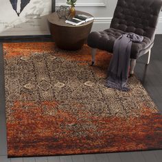 an orange and brown rug in a living room