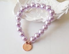 This personalized flower girl bracelet is made with lavender color little glass pearls (8 mm) and rose gold plated initial disc. This stretch pearl bracelet is perfect gift for your flower girls, jr bridesmaids or bridesmaids. Please visit my store to see the other wedding jewelry https://www.etsy.com/shop/asteriasbridal Elegant Personalized Rose Gold Beaded Bracelets, Elegant Personalized Rose Gold Beaded Bracelet, Personalized Rose Gold Charm Bracelet For Wedding, Wedding Pearl Bracelet, Lavender Bracelet, Gold Flower Girl, Junior Bridesmaid Gifts, Flower Girl Jewelry, Flower Girl Bracelets