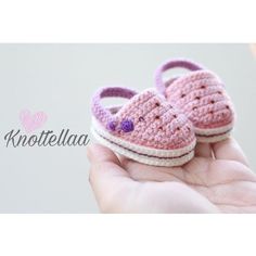 small crocheted pink and white baby shoes