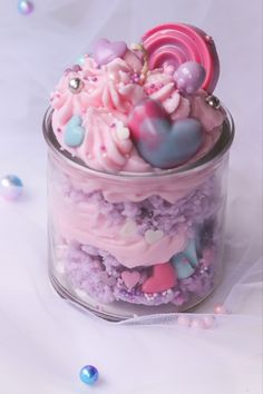 a jar filled with lots of pink and purple stuff