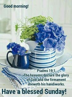 a blue and white vase filled with flowers sitting on top of a table next to a napkin