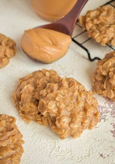 peanut butter oatmeal cookies cooling on a rack with a wooden spoon next to them