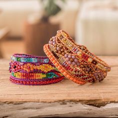 two bracelets sitting on top of a wooden table