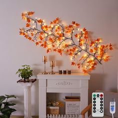 a living room with a white fireplace and some lights on the wall next to it