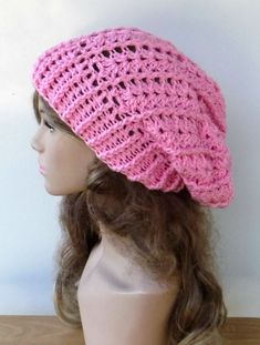 "The pink lacy stretchy slouch hat for women or teens. Beautiful color in cheery pink. Worked in a pretty relief and lace weave and a stretchy rim it makes a great all-year-around beanie. Stretchy and ideal to wrangle your hair! Soft, sturdy and colorfast acrylic yarn, easy laundry care. Measurements: 11 inches LONG (depth) Head opening is about 18 inches unstretched and stretches to 26 inches Widest point 10,5\" This hat still has some stretch in width and length if needed. Ideal for tucking a Bonnet Au Crochet, Crochet Slouchy Hat, Visor Beanie, Lace Weave, Handmade Beanies, Slouchy Beanie Hat, Bonnet Crochet, Pink Crochet, Custom Crochet