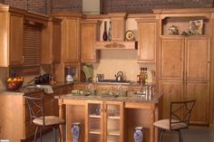 a kitchen with wooden cabinets and marble counter tops