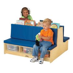 two children sitting on a blue bench with books