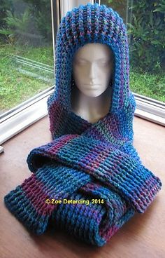 a crocheted blue and purple hooded scarf on a mannequin's head