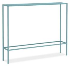 a blue metal shelf sitting on top of a white wall