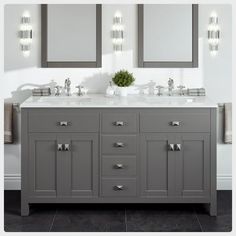 a bathroom vanity with two mirrors and lights on it's sides, in front of a white wall