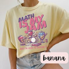 Math Is My Jam - Comfort Colors 1717 Tee Description: Celebrate your love for numbers and equations with our "Math Is My Jam" t-shirt! Perfect for math teachers, students, or anyone who adores the beauty of mathematics, this tee is a stylish and comfortable way to show off your passion for the subject that makes the world go round. Key Features: Premium Quality: Crafted from 100% ring-spun cotton, the Comfort Colors 1717 tee is known for its soft, durable fabric that only gets softer with each w Bookish Jewelry, English Teacher Shirt, Volleyball Shirts, Pom Pom Girl, Lovers Romance, It Shirt, Sped Teacher, My Jam, Comfort Colors Shirt