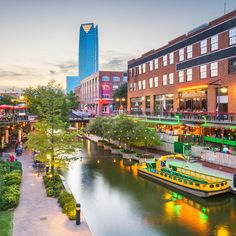 a river running through a city next to tall buildings