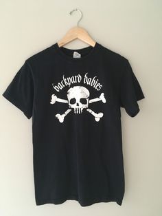 Original official vintage Backyard Babies band tee. Excellent vintage condition with no tears or stains. Tag: Golden Heavy Cotton Size : S Standard unisex size small. Measures: shoulder to hem: 26 inches armpit to armpit: 19 in chi ea Free shipping! Unisex Cotton T-shirt With Skull Print, Cotton Grunge T-shirt With Skull Print, Unisex Cotton T-shirt With Band Logo, Rocker Style Distressed Crew Neck T-shirt, Distressed Cotton Band Merch T-shirt, Distressed Cotton T-shirt Band Merch, Rocker Distressed T-shirt For Concert, Alternative Style Cotton T-shirt For Music Festival, Skull Print Streetwear T-shirt