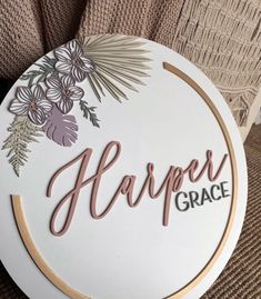 a white sign that says harper grace with flowers and leaves on the bottom of it