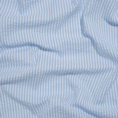 Evoking the easygoing lifestyle of a coastal New England town, this Wylie Light Blue and White Candy Striped Polyester and Cotton Seersucker is a sweet summer treat. The lightweight nature of seersuckers make them a functional fabric for warm weather climates; the puckered face feels cool on your skin as the easy drape catches the breeze. Often seen in stripes or checkers, this specific seersucker is lined with light blue and white candy cane stripes—a simple yet playful demonstration of color. Seersucker Aesthetic, New England Town, England Town, Coastal New England, Blue And White Fabric, Italian Riviera, Seersucker Fabric, Candy Cane Stripes, Mood Fabrics