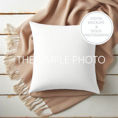 the simple photo pillow is displayed on a wooden surface with a tan blanket around it