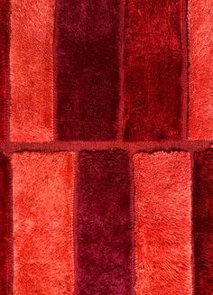 a red and purple rug with squares on it