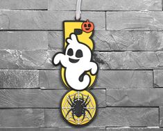 a cartoon character hanging from the side of a wall with a spider web on it