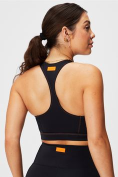 Zip-Front Racerback Shaping Swim Top Fabletics black/orange female Activewear >> Womens >> Swim >> Tops regular Swim 4-Way Stretch/Removable Bra Cups Zip-front racerback swim top. Sports Bra With Padded Back, Sports Stretch Bra With Padded Back, Fitted Sports Bra With Padded Back, Stretch Activewear With Padded Back For Sports, Sporty Activewear With Padded Back For Workout, Black Sporty T-back Activewear, Stretch Racerback Activewear With Padded Back, Athleisure Activewear With Padded Racerback, Padded Back Stretch Sports Bra