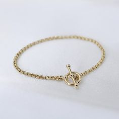 "14K GoldToggle Rolo Chain Bracelet - 14K Gold 2mm Rolo Chain Bracelet ★ 14K gold 2mm rolo chain ★ 14K gold toggle clasp ★ All components are 14K solid yellow gold The length includes the chain and the closure. Please measure your wrist before you place your order. ** How to choose a correct size of bracelet. 1. Measure your wrist below the wrist bone using a flexible tape measures, a string or a strip of paper. 2. If using a string or a strip of paper, mark length. Then, measure it with a ruler Timeless 14k Gold Chain Bracelet With Spring Ring Clasp, Classic Gold Bracelet With Toggle Clasp, Yellow Gold Plated Bracelet With Toggle Clasp, Yellow Gold-plated Bracelet With Toggle Clasp, Everyday Yellow Gold Chain Bracelet With Toggle Clasp, Classic Yellow Gold Bracelet With Toggle Clasp, Everyday Yellow Gold Bracelets With Toggle Clasp, Elegant Yellow Gold Bracelet With Toggle Clasp, Elegant Yellow Gold Toggle Necklace Tarnish Resistant