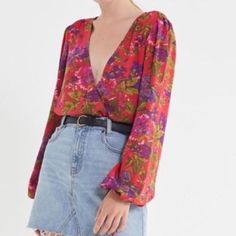 New Urban Outfitters ‘Georgie’ Blouse. Plunging, Surplice Neckline With Hook And Eye Closure. Lightweight Fabric In A Relaxed Fit. Long Balloon Sleeves With Ties At The Cuffs. Small Slits At The Side Seams. Red With A Pink And Purple Floral Print. 100% Rayon. Size Xs. Urban Outfitters Long Sleeve Tops With Floral Print, Urban Outfitters Long Sleeve Top For Brunch, Urban Outfitters V-neck Blouse For Fall, Trendy V-neck Blouse By Urban Outfitters, Urban Outfitters Long Sleeve Blouse For Day Out, Spring V-neck Blouse By Urban Outfitters, Urban Outfitters V-neck Spring Blouse, Urban Outfitters V-neck Blouse For Spring, Urban Outfitters V-neck Blouse For Brunch