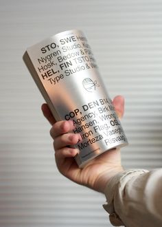 a person holding a can of coffee in their left hand with the words on it