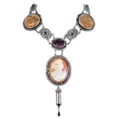 Jill Garber Antique Goddess Cameo, Amethyst with French Medals Drop Necklace | From a unique collection of vintage Drop Necklaces at https://www.1stdibs.com/jewelry/necklaces/drop-necklaces/. Luxury Vintage Amethyst Jewelry, Luxury Cabochon Medallion Necklace, Luxury Oval Cameo Necklace, Luxury Cameo Medallion Jewelry, Luxury Medallion Necklace With Intaglio, Luxury Oval Pendant Necklace For Collectors, Ornate Cameo Jewelry For Formal Occasions, Ornate Oval Cabochon Necklaces, Victorian Cabochon Oval Pendant Jewelry