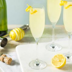 three glasses of champagne with lemons on the side